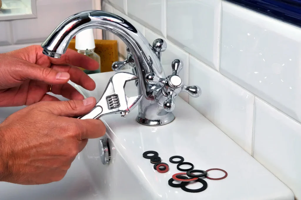 Plumber performing maintenance on a bathroom faucet in Cartersville
