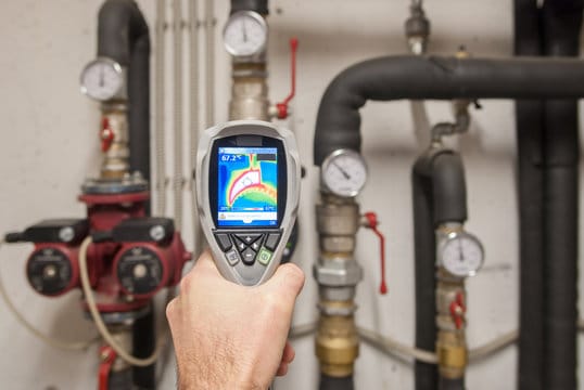 Plumber using a thermal imaging camera to inspect pipes in Cartersville