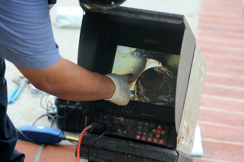 Technician viewing a drain inspection camera in Cartersville
