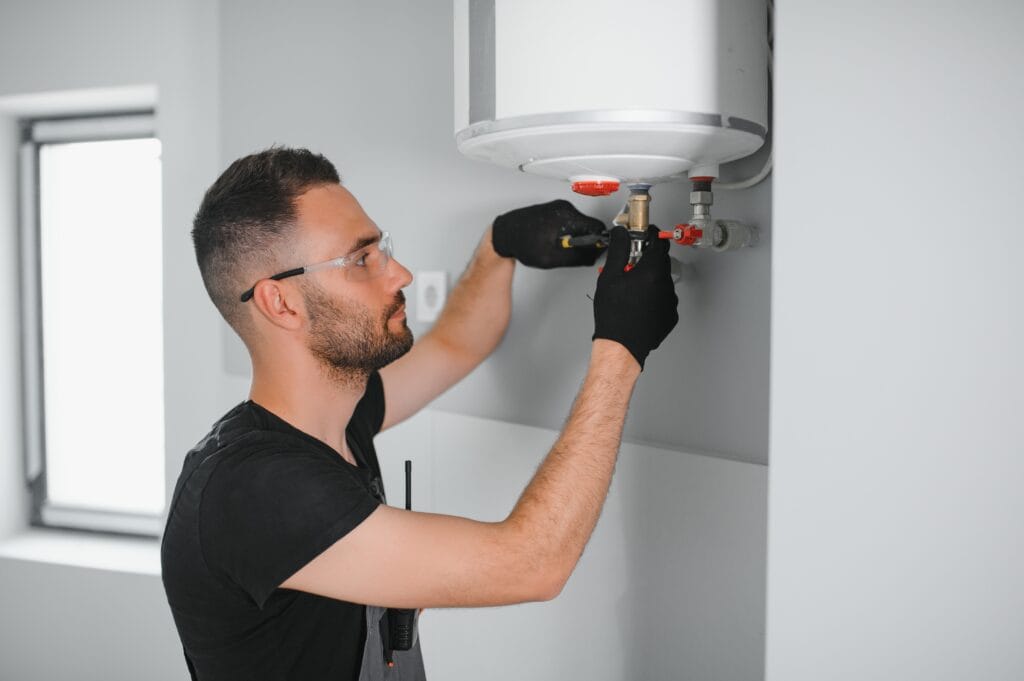 Technician performing water heater maintenance in Cartersville