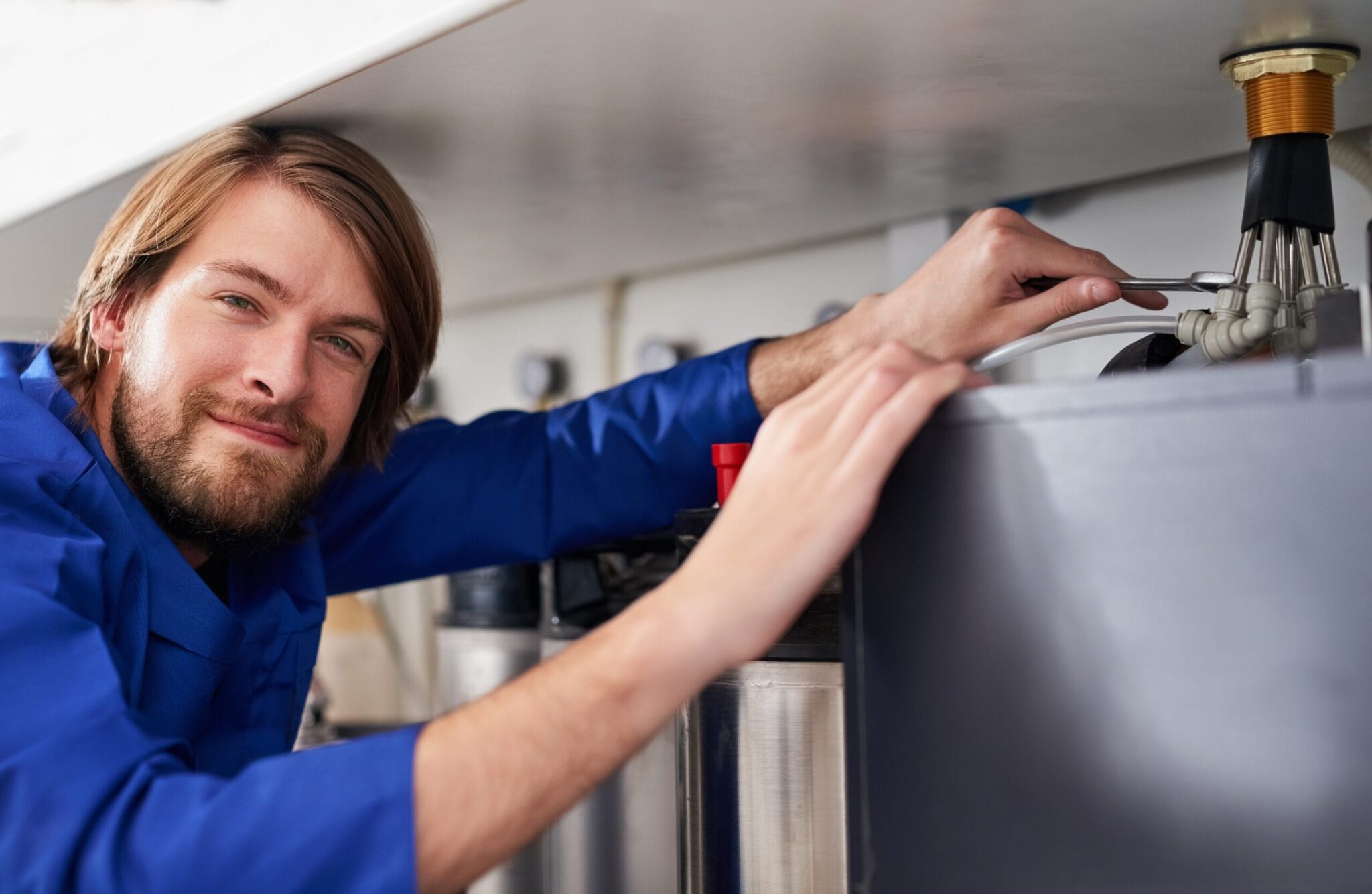 Technician servicing a residential water heater tank in Cartersville