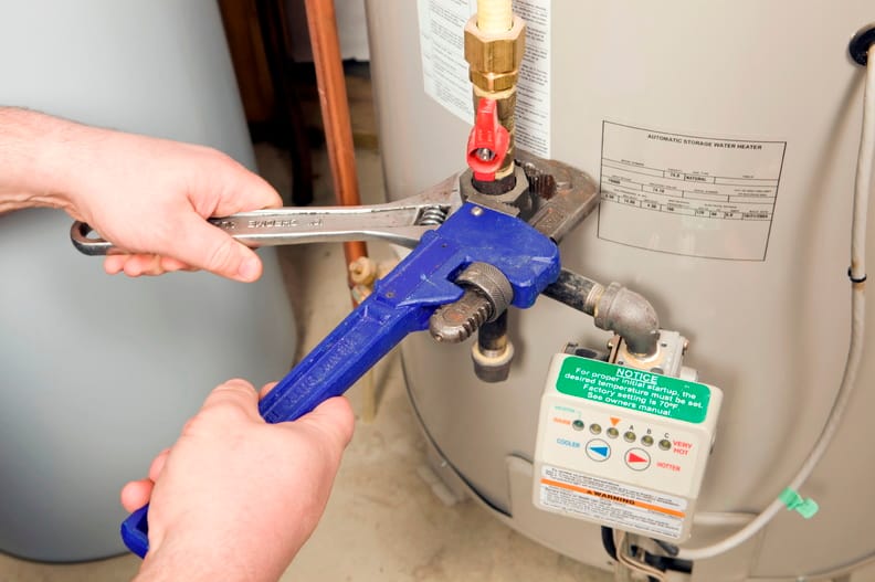 Plumber repairing a water heater valve in Cartersville